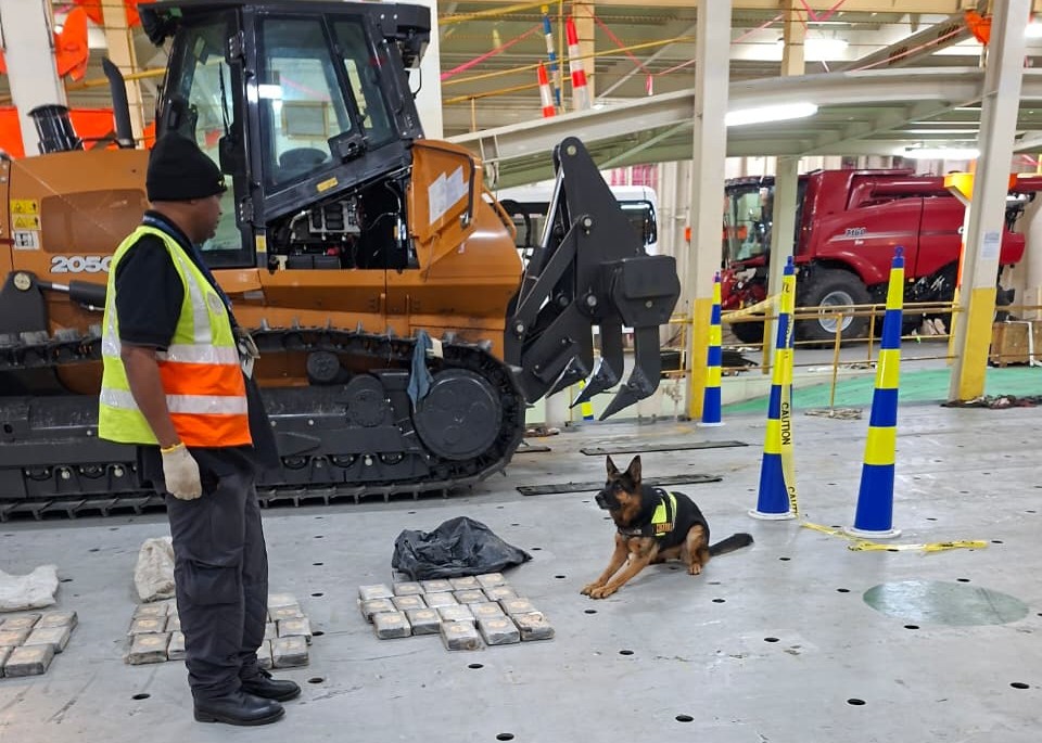 A K9 unit assists in detecting cocaine concealed in an excavator from Brazil at Durban harbour.