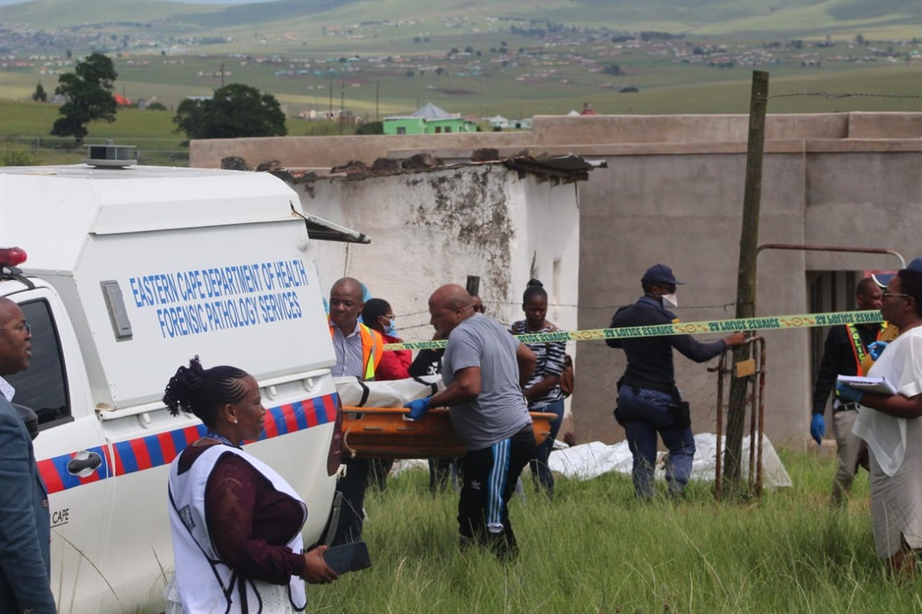 Forensic pathology officials removing a victim fro