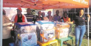 Director assists children with blankets