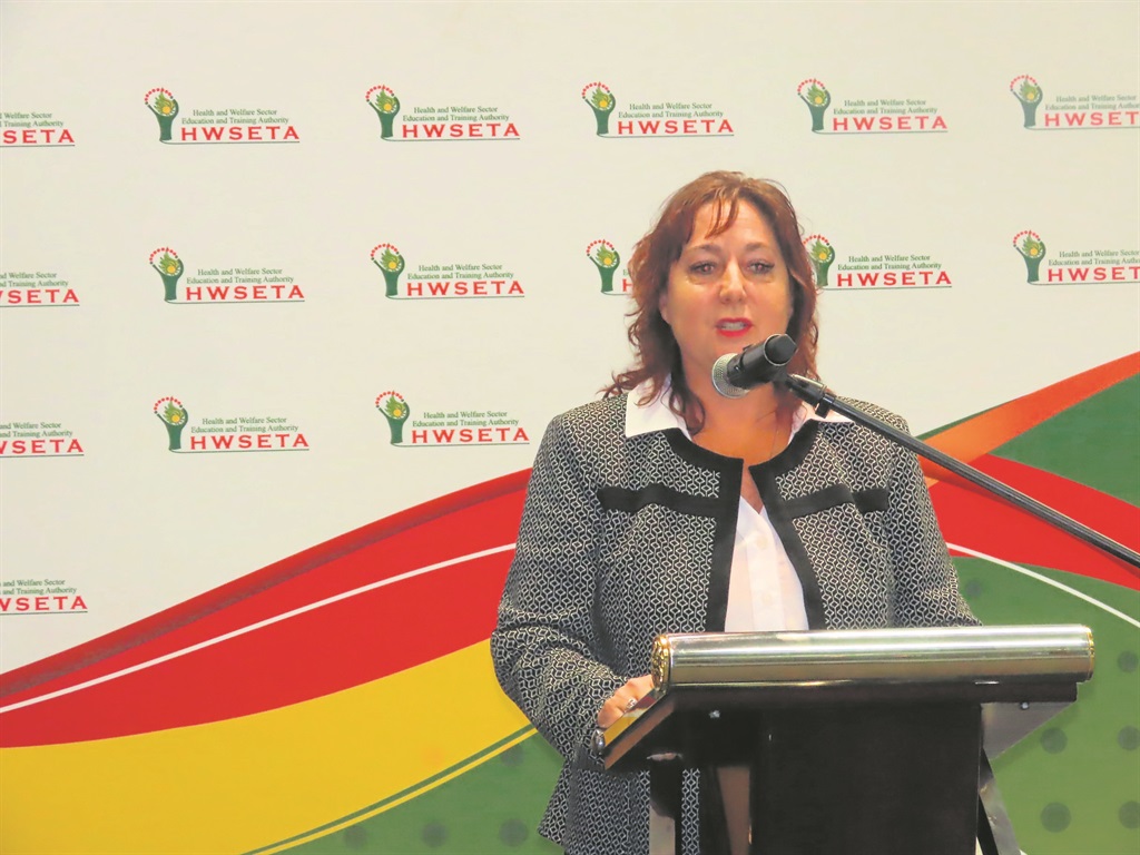 laine Brass, CEO of HWSETA, congratulates the grad