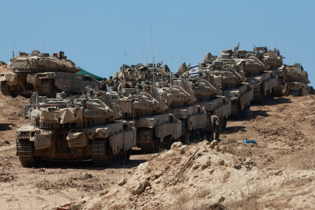 A convoy of Israeli tanks is deployed at Israel's border with the Gaza Strip. (Photo by Menahem Kahana / AFP)