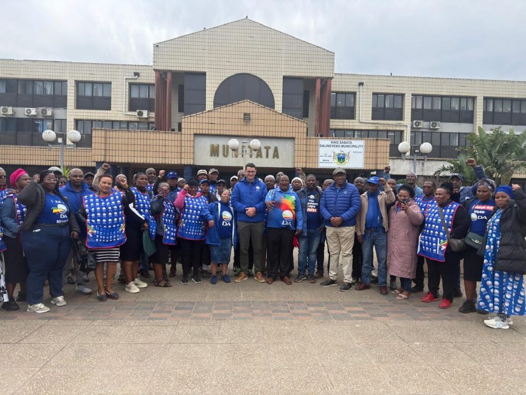Members of the Democratic Alliance pausing outside the building of King Sabatha Dalindyebo Local Municipality in Mthatha.
