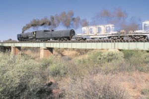 Steam locomotive thundering across landscape between Kimberley and Bloemfontein