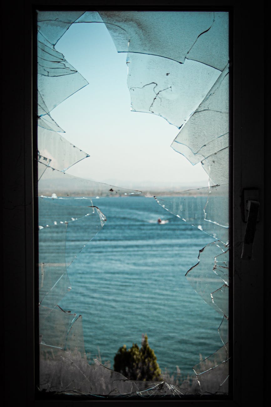 scenic view through broken glass window