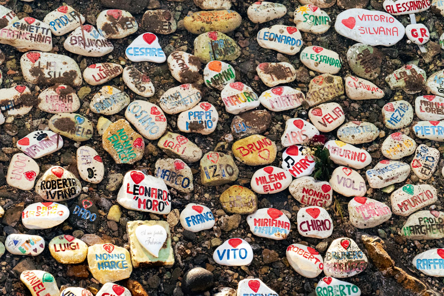 colorful painted stones displayed on italian beach