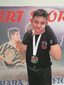 Young Kickboxer kicks . . . for medals