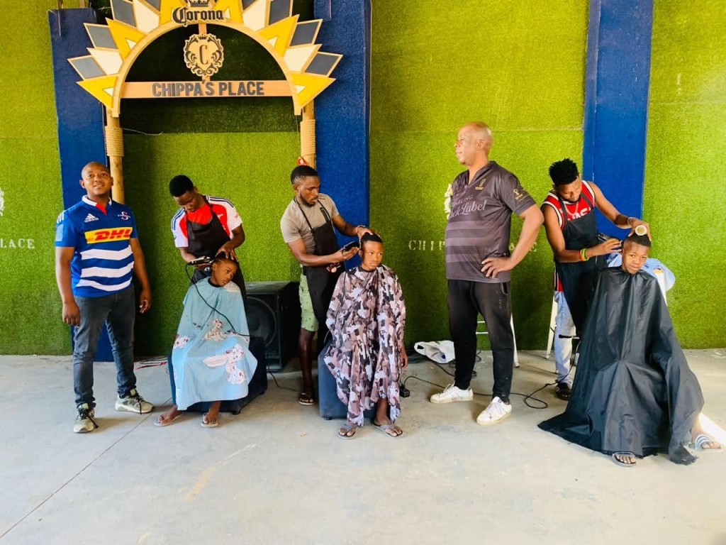 Gravel (far left) says 150 boys received free haircuts. Photo: Supplied