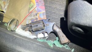 Man arrested at accident scene with unlicensed firearm