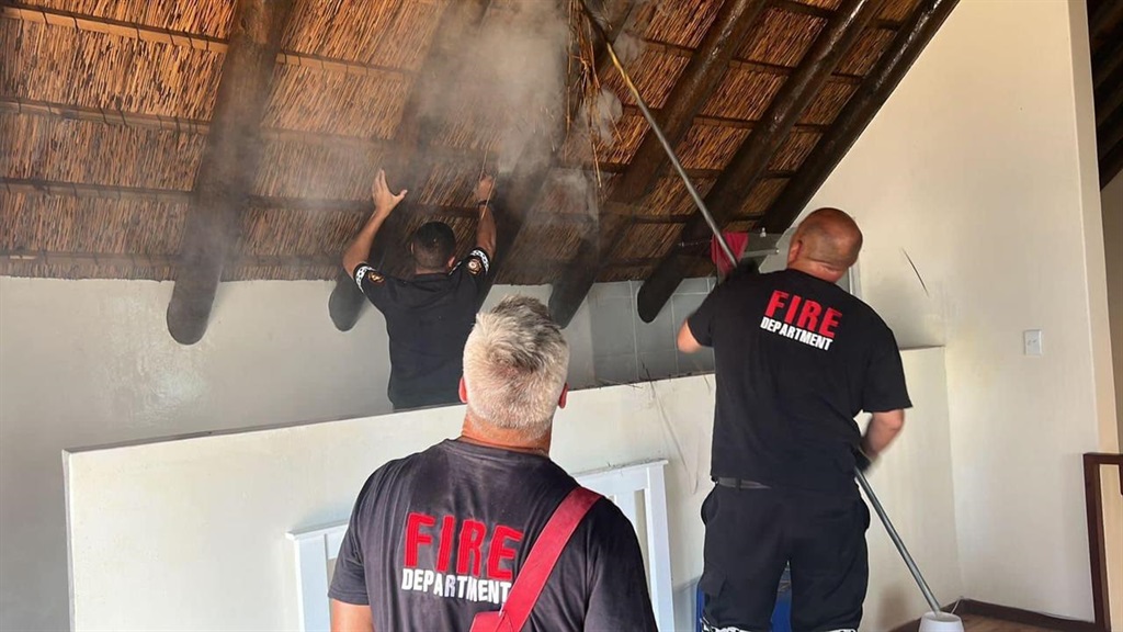 Fire fighters putting out a fire at a house in Bea