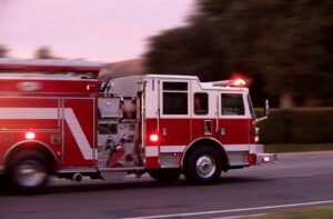 Woman dies after blanket she slept under caught alight