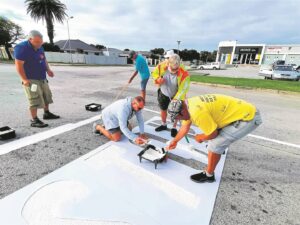 Residents come together to repaint street markings