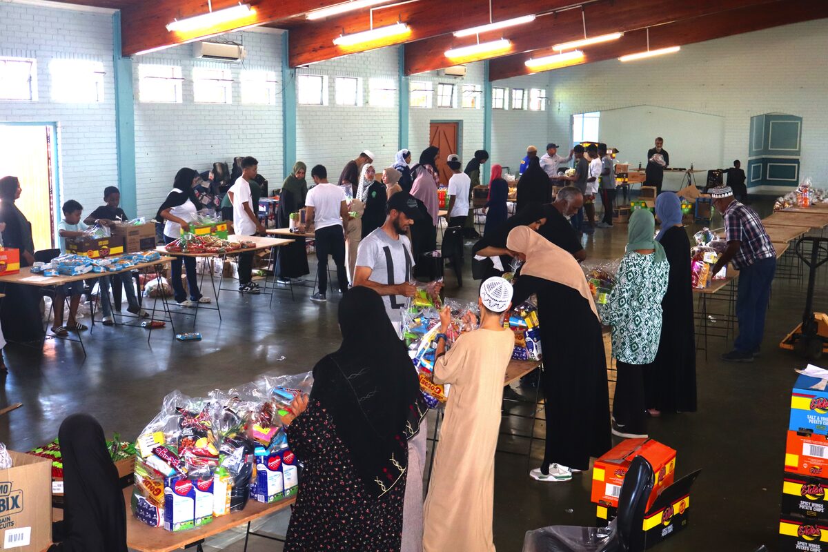 Community members creating a production line for hamper packing.