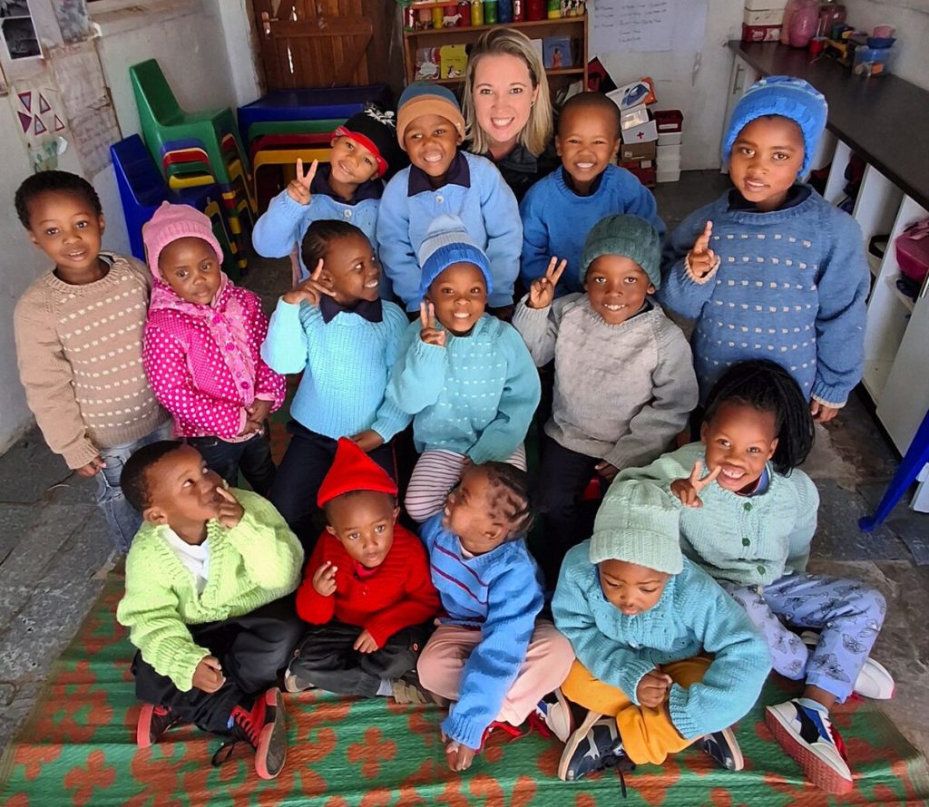 Colette Theron (Marketing Manager at Community Chest) with some of the little learners at Kamvalethu Day Care.