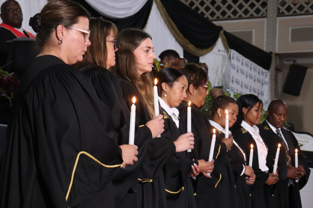 New Brighton prosecutors lighting a candle in memory of Tracy Brown as a symbolic act of remembrance and honour.