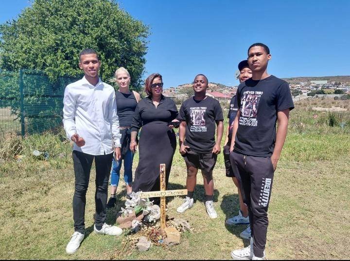 Family and friends of Tristan Jacobs gathered at a wooden cross that marks the spot where he died next to Stanford Road.