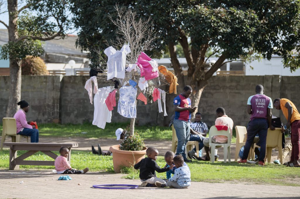Migrants take refuge outside a community hall in Stanford, near Hermanus, on Friday 5 June. Photo: Rodger Bosch/AFP