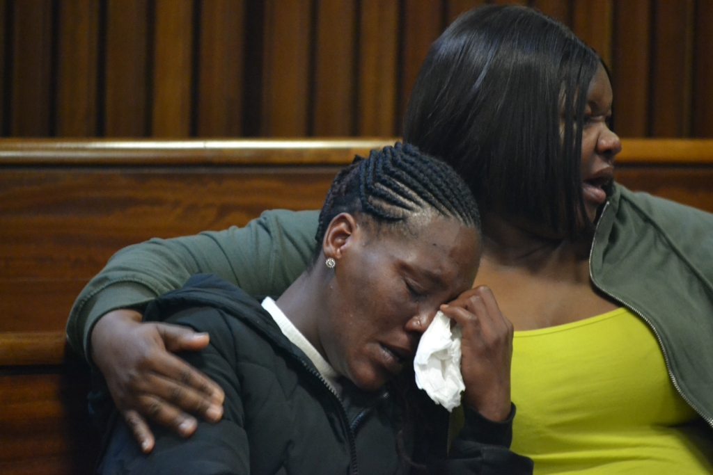 Pictured is the distraught mother of Veronique, Destiny May being comforted.
