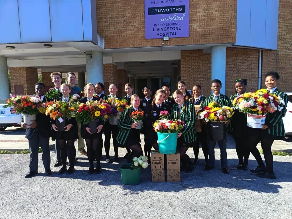 Pearson Interact Club members deliver flowers to Livingstone Hospital patients.