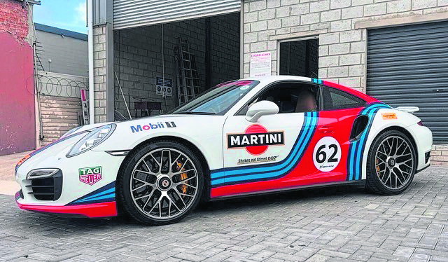 A Porsche race car in classic Martini Racing livery — the kind of high-performance pedigree set to thrill crowds.