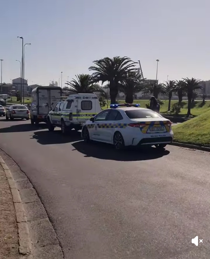 A screenshot of a video shows metro police and police escorting the delivery bakkie out the area. Photo: Supplied