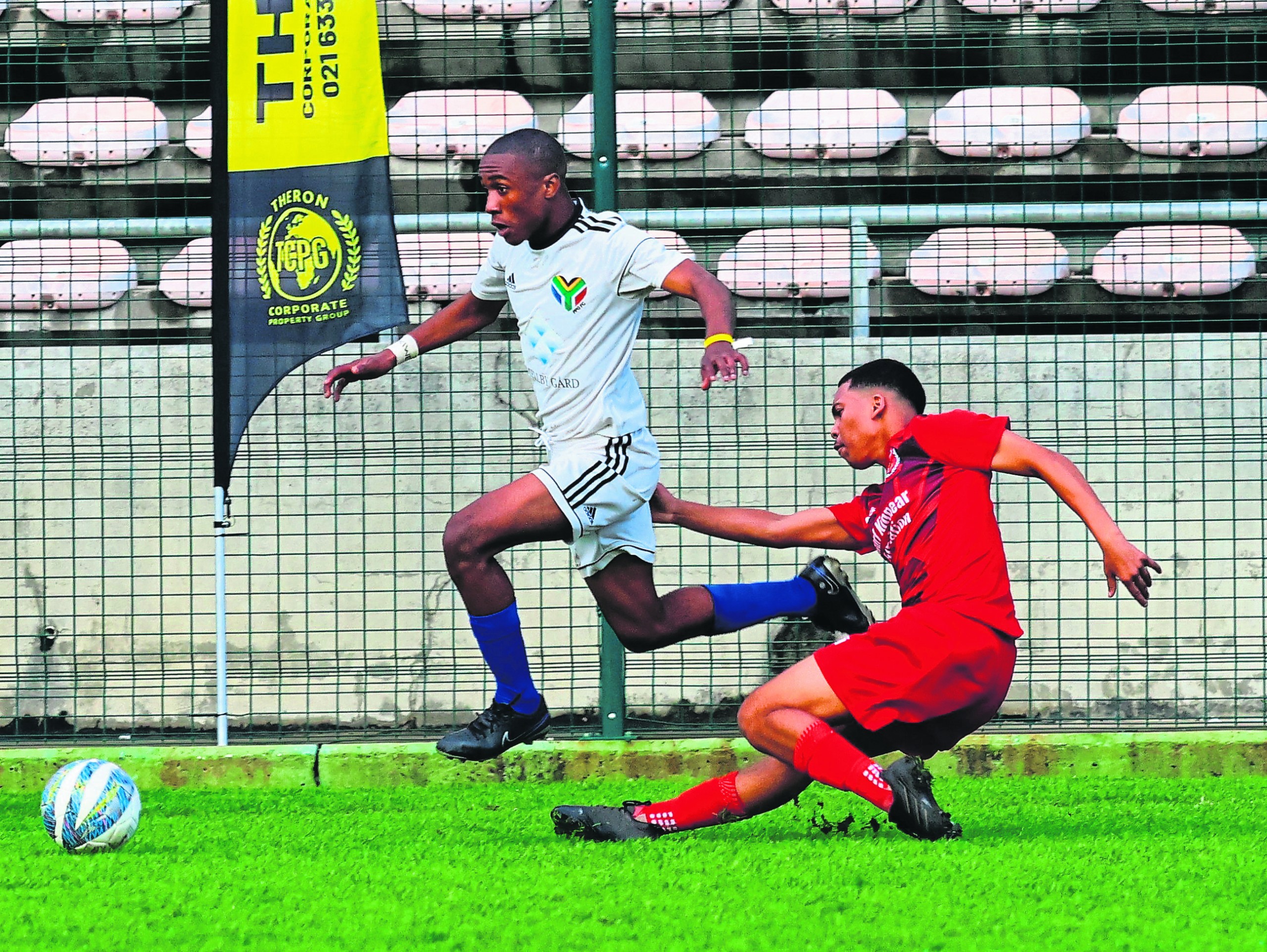 Lihle Somana of PPG Langa beats a sliding tackle by Reyaan Manuel of Norway Parks. Photo: Rashied Isaacs