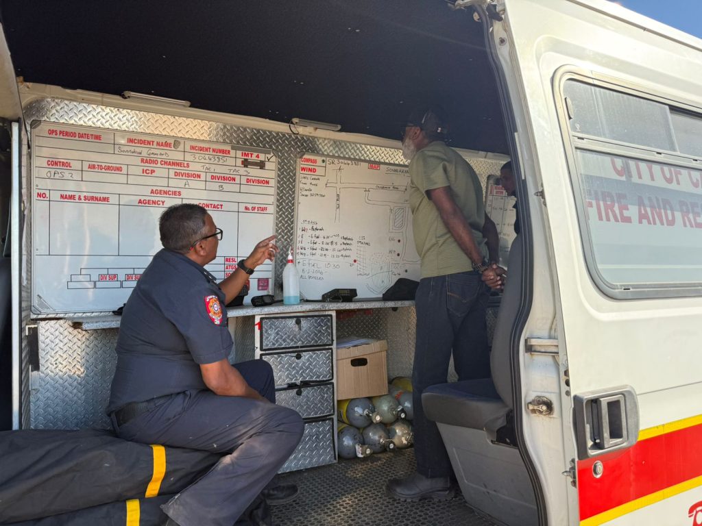 Emergencey services strategise hose best to tackel the fire