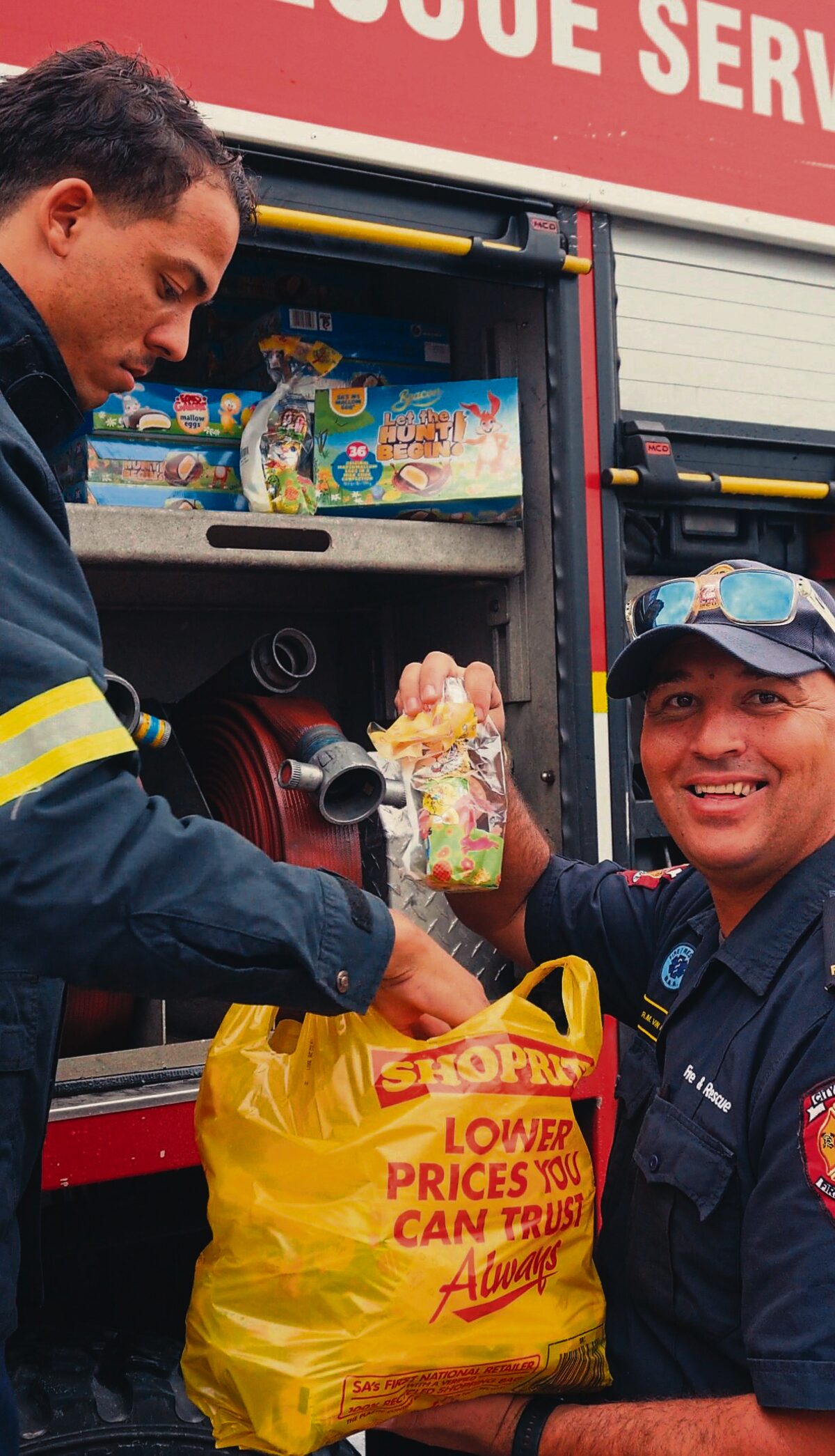 Representatives from Shoprite and the City of Cape Town's Fire and Rescue Service prepare Easter donation packages at Holy Cross Educare.