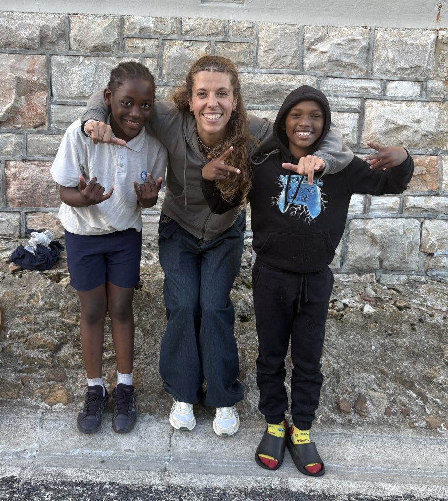 Surfpop coach Tessa Klien alongside the young surfers, Theodora Manzvire and Luthemba Munuza, who competed on the day.