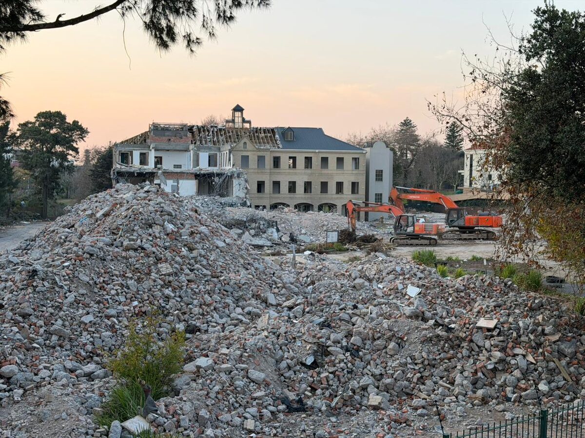 Demolition of the old Tannery Park building in Belmont Road, Rondebosch, with heavy machinery clearing the site for the proposed 505-unit development
