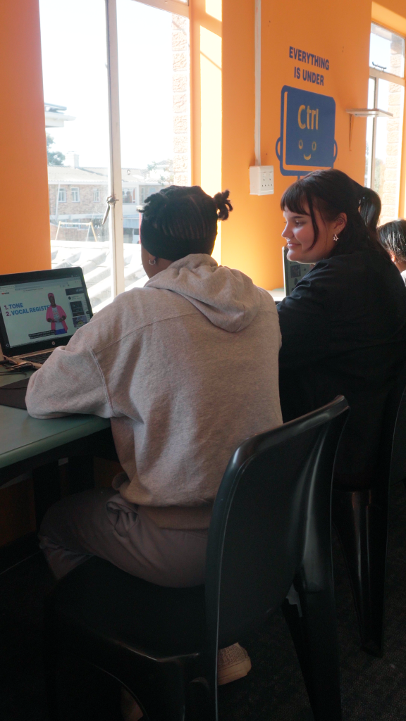 Two women standing in front of a PC