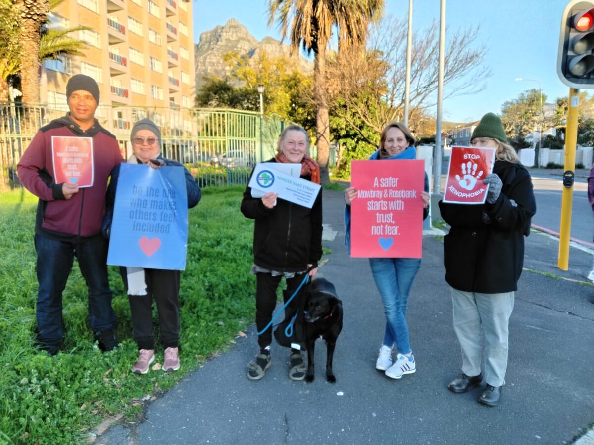 Residents holding anti-xenophobia placards at the Durban Road and Liesbeek Parkway intersection in Mowbray during a peak-hour solidarity demonstration on 30 June.