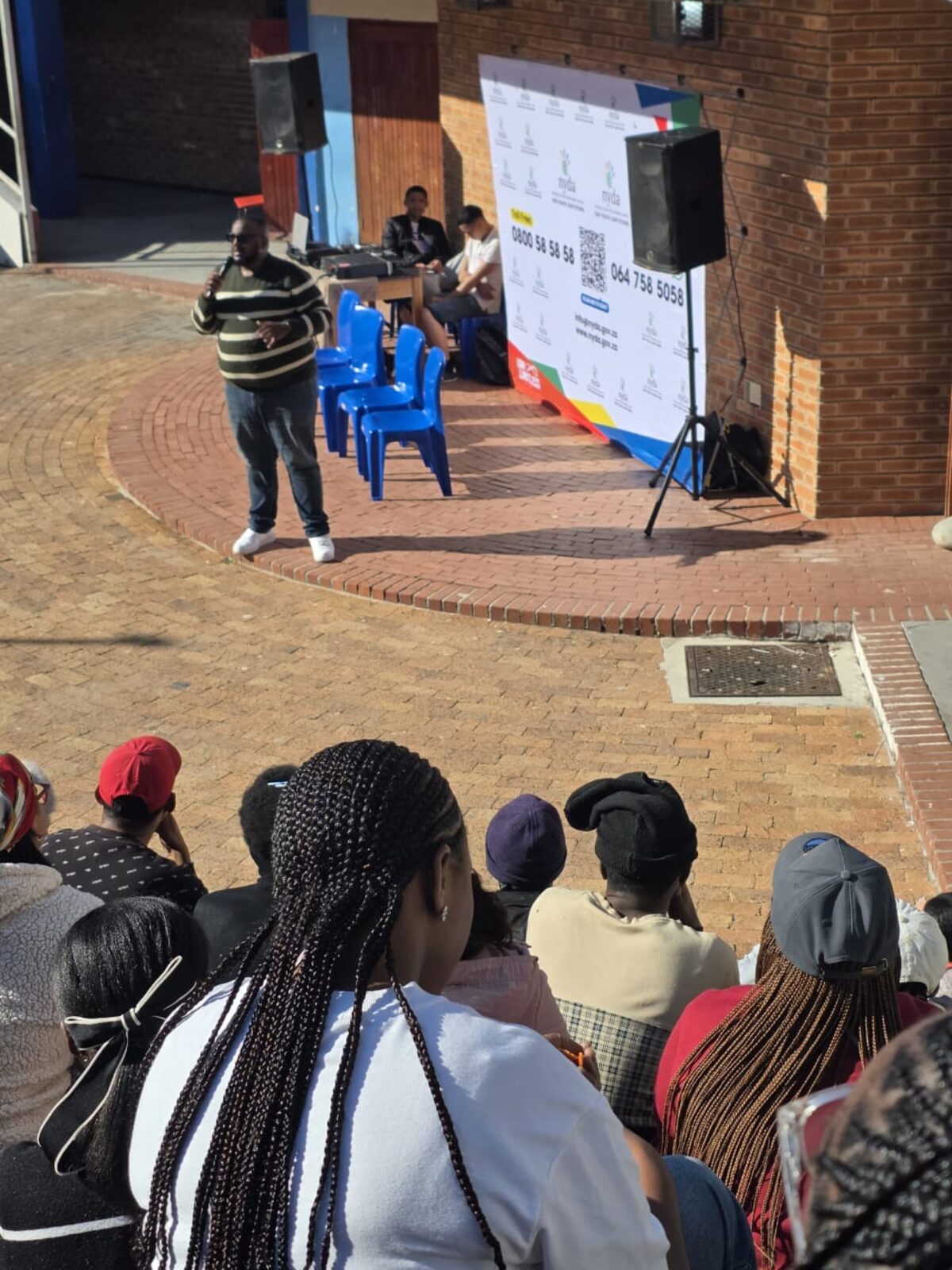 A National Youth Development Agency representative delivers a speech to residents at the Hout Bay Youth Dialogue on Unemployment and Opportunity at Hout Bay High School Hall on Monday 13 July 2026.