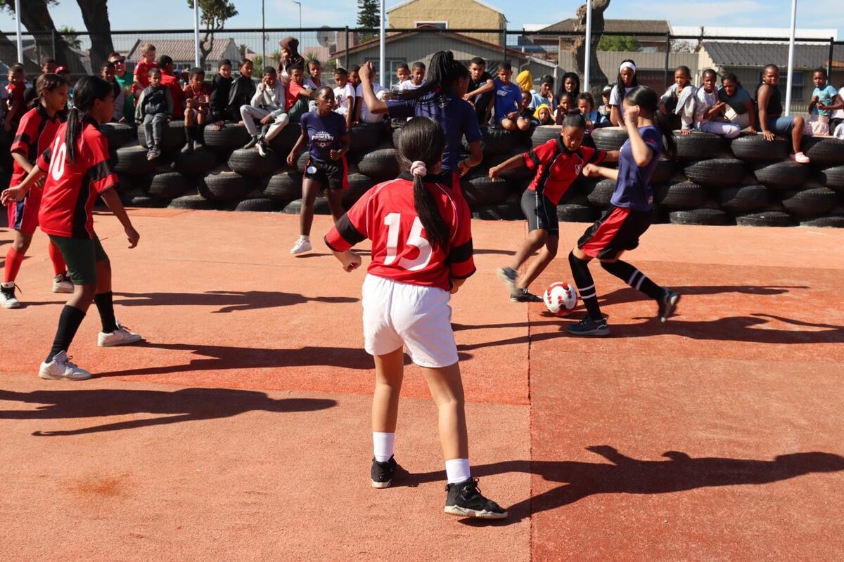 Learners at Vanguard Primary School in Heideveld play on a new five-a-side football pitch made from upcycled padel court turf.