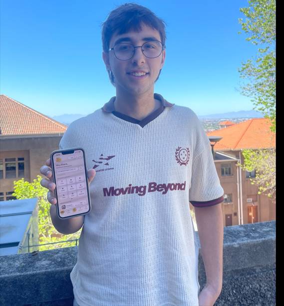 Dylan Steiner, a first-year business science student at the University of Cape Town, holds up his Bites app, which lets diners compare restaurant prices and find better value for money.