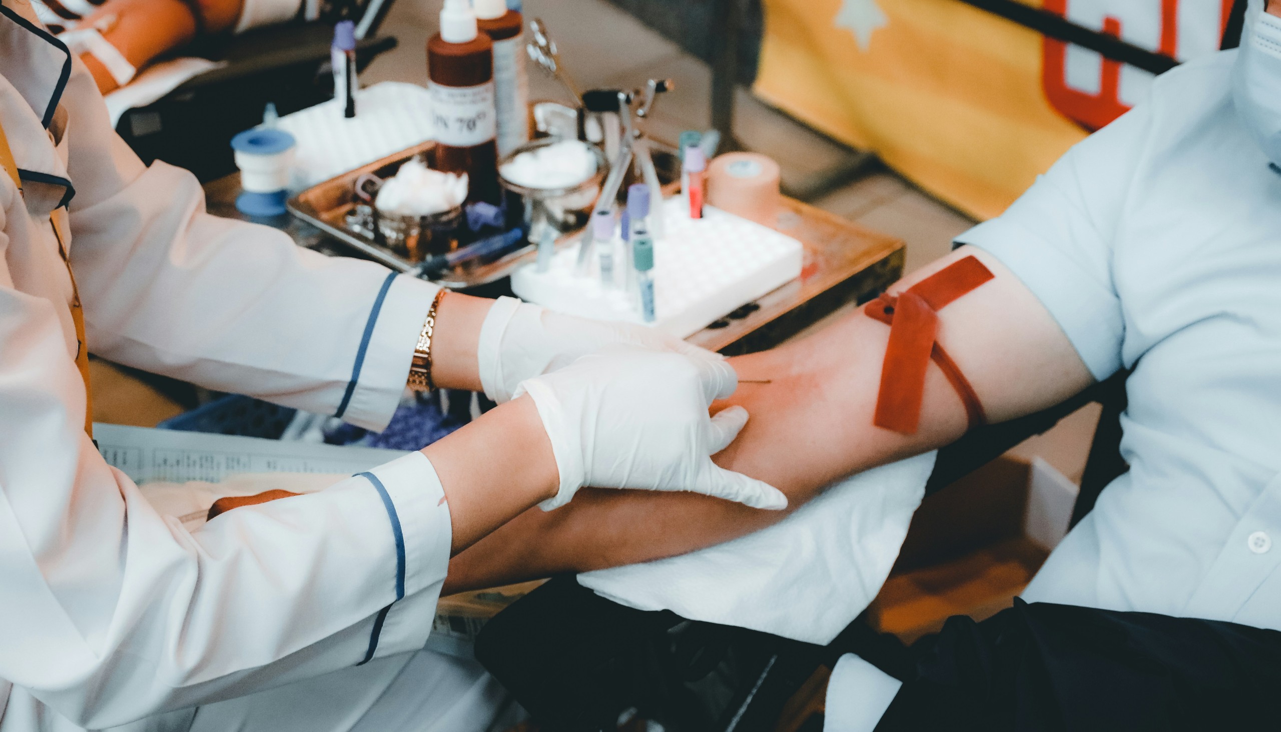A nurse helping a blood donor.