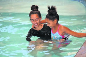 ‘I don’t even know about my leg when I’m in the pool’: Courageous young amputee finds freedom in water