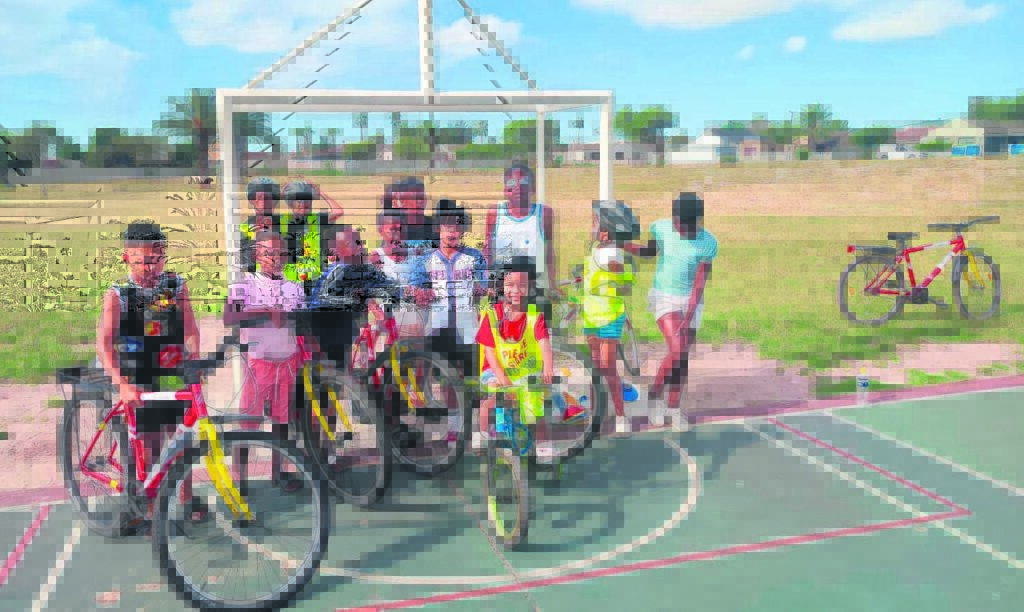 Photo of youngsters with bicycles.
