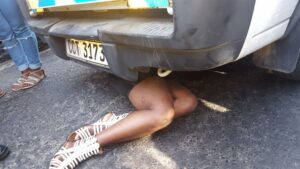 Trader throws herself under cop vehicle
