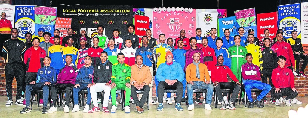 The captains of all the teams taking part in the Bayview Youth Cup with Mitchell's Plain Local Football Association president Gilbert Kruger, in blue jacket; Bayview chair Mark Rodrigues, in brown jacket; and Duncan Crowie, former Santos player. Photo: Thulani Magazi