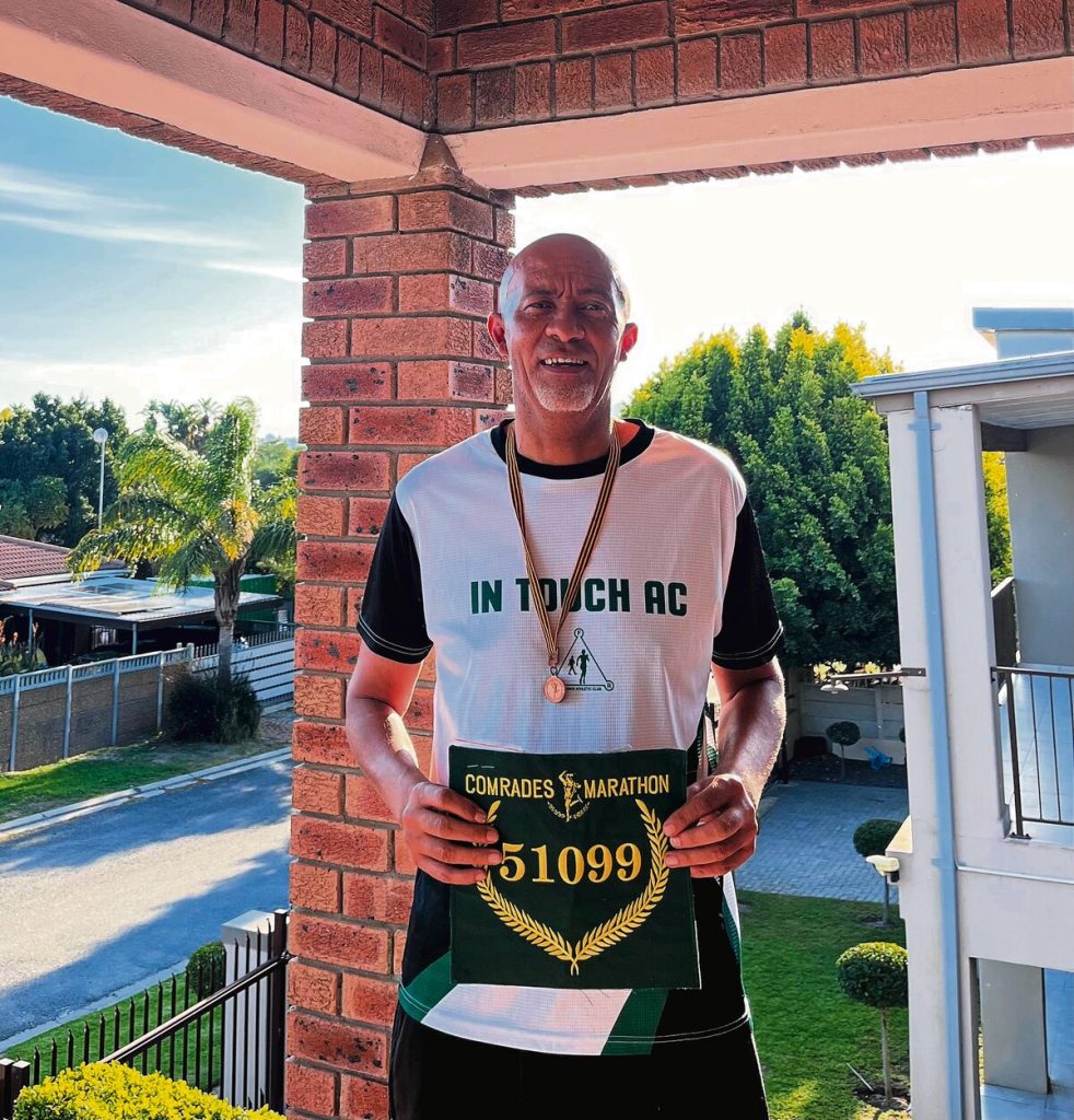 Pastor Philip Bosman with his Comrades green number.