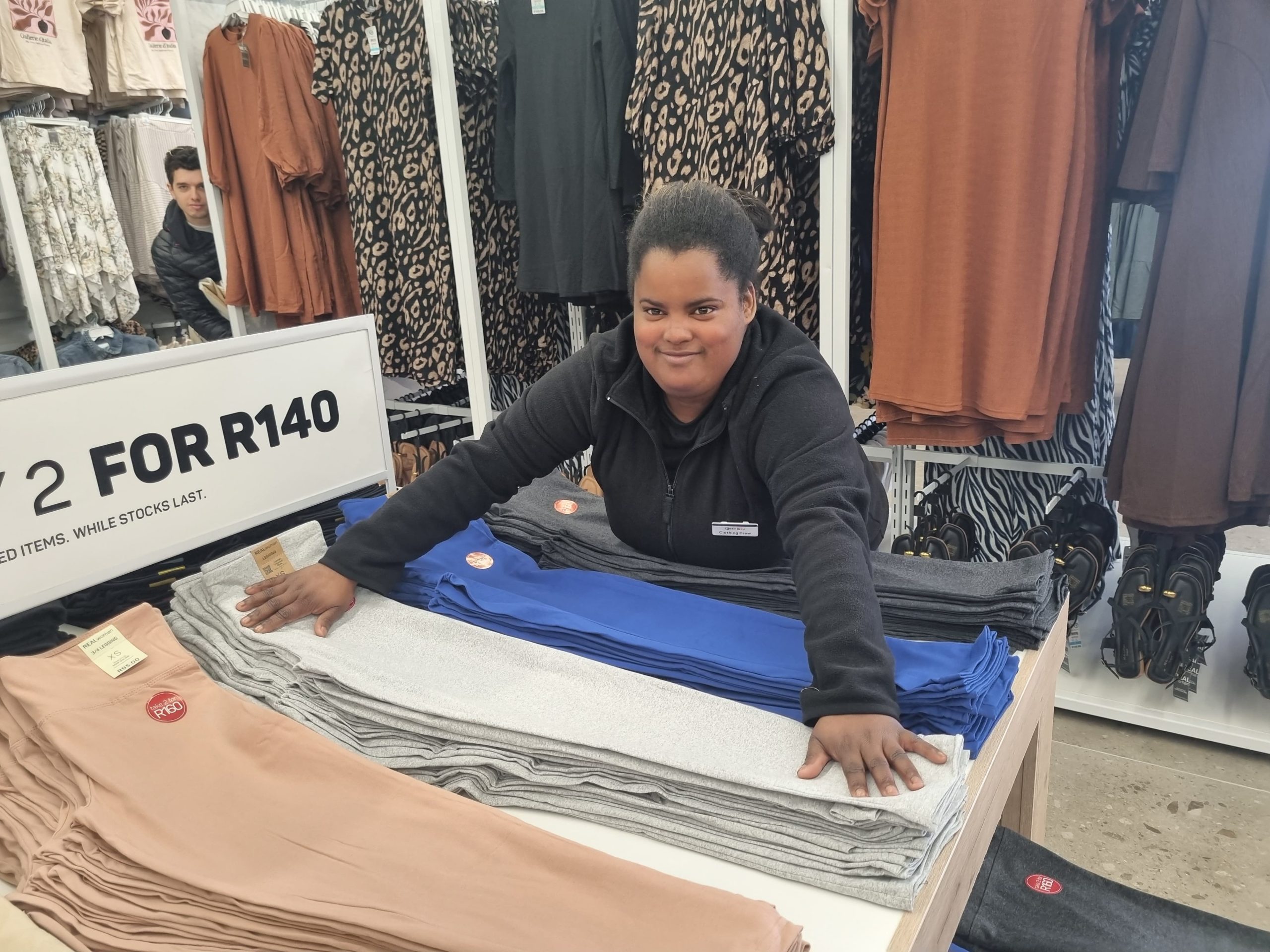 Elajah Carolisen of PnP Clothing makes sure the clothes display is tidy and neat.