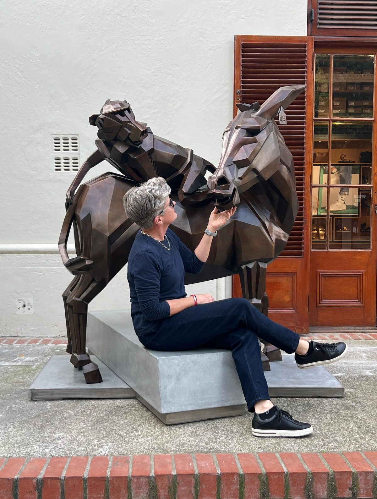 Jean Theron Louw with a life-size sculpture of her work Ass'n About, which is currently on display in front of the Art on Church Gallery in Church Street, Stellenbosch.