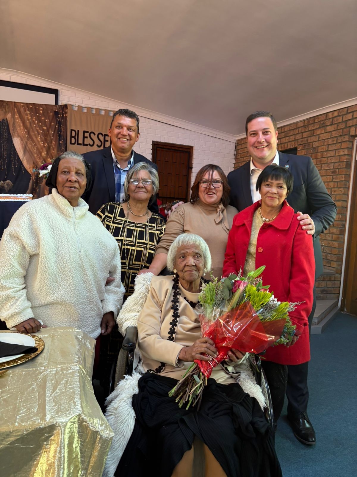 Georgina Wilemina Davids, seated in front, is flanked by (second row, from left) her younger sister Selina Wheeler, her eldest daughter Elizabeth Retief, her youngest daughter Rita Scheffers and her middle daughter Monica van der Westhuizen. At the back is Councillor Ashley Potts and Cape Town Mayor, Geordin Hill-Lewis.