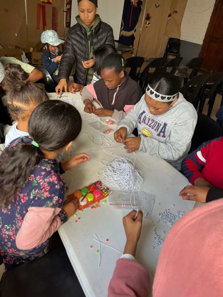 Children make name bracelets at Advance Edukos's Mandela Day Programme