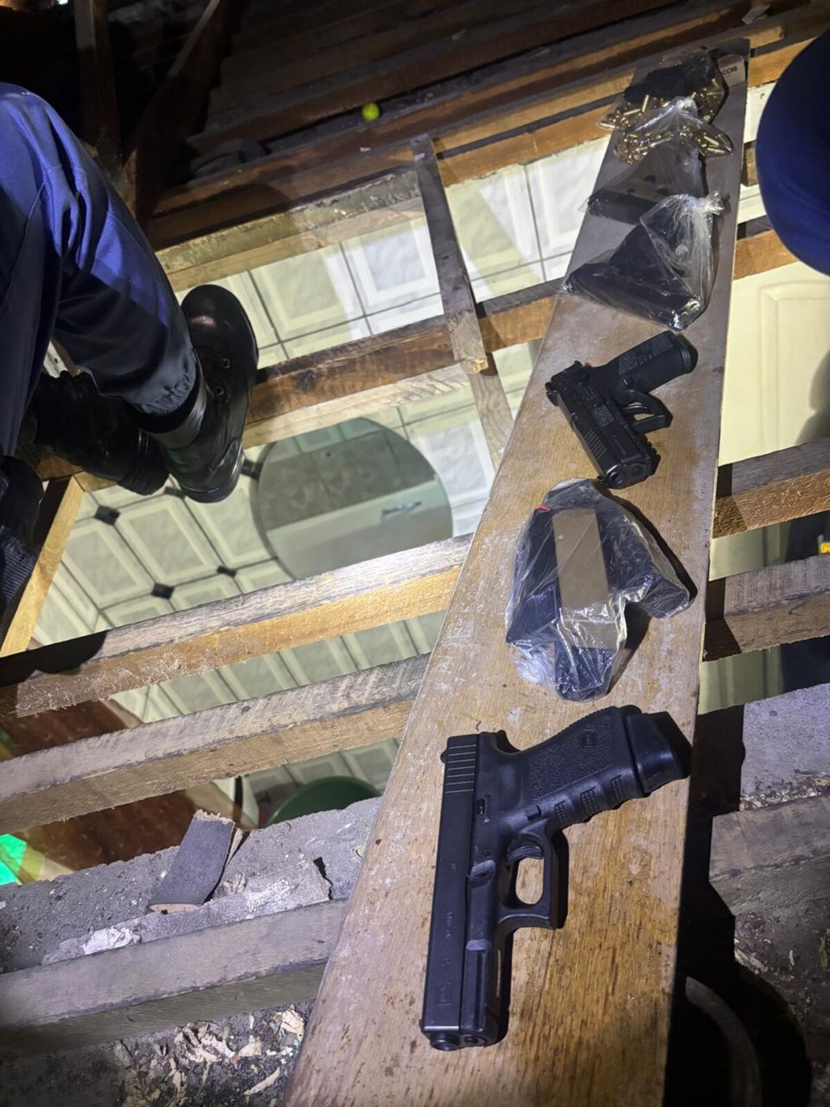 Police found four guns and ammunition in the roof of a Tafelsig house on Monday.