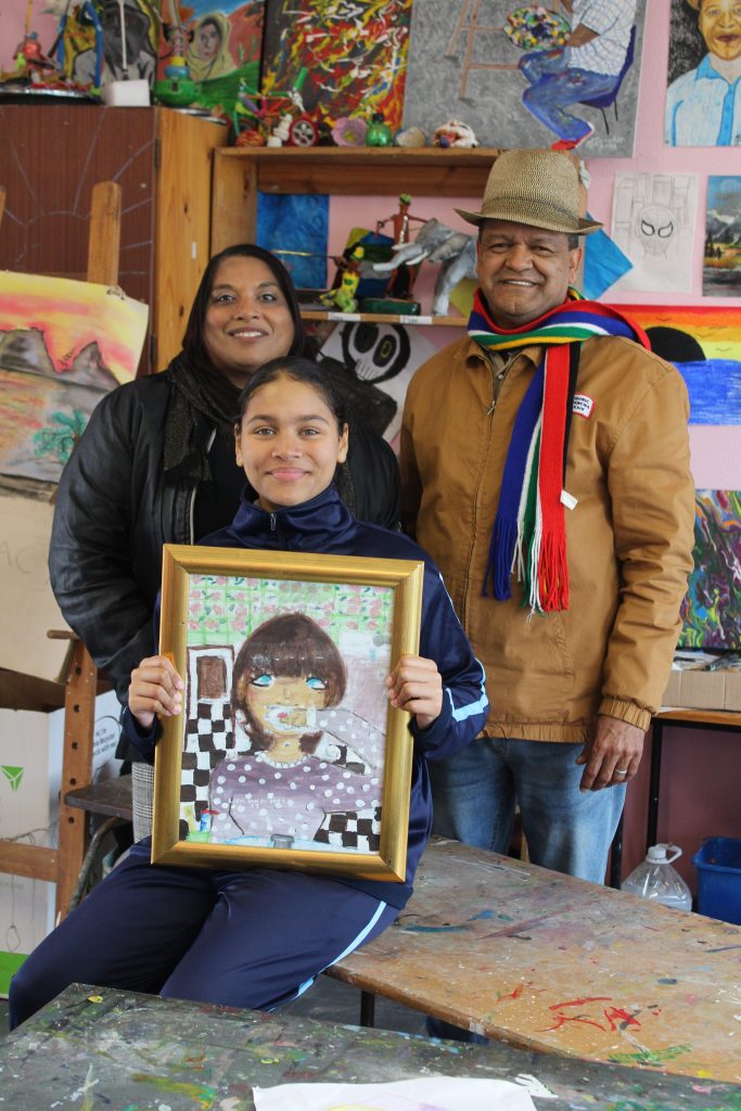 Lucia van der Ross (11) with her class teacher Kautha Samuels and her art teacher Mark Jeneker. Lucia came third in the National Science Week Art Competition 2025.