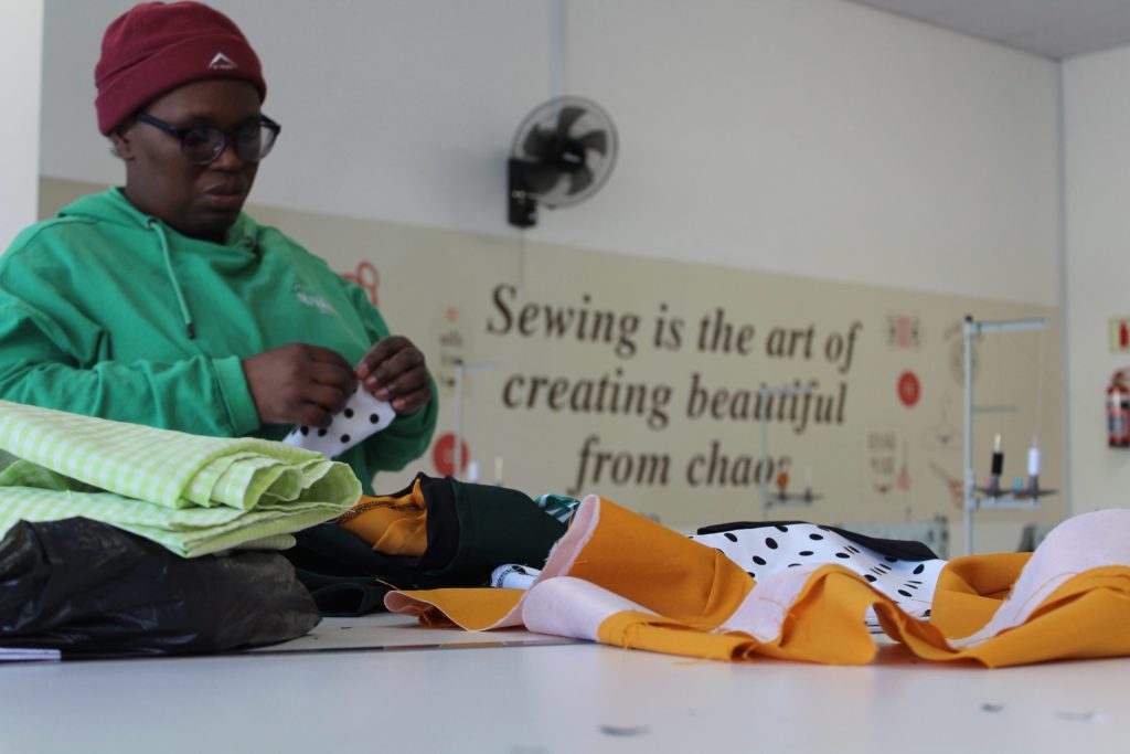 Thandokazi Manquina of Philippi pins fabric at the TCM Skills Centre. The centre, which will have its grand opening this week, gives free training in patisserie design, culinary skills, sewing and computer studies.