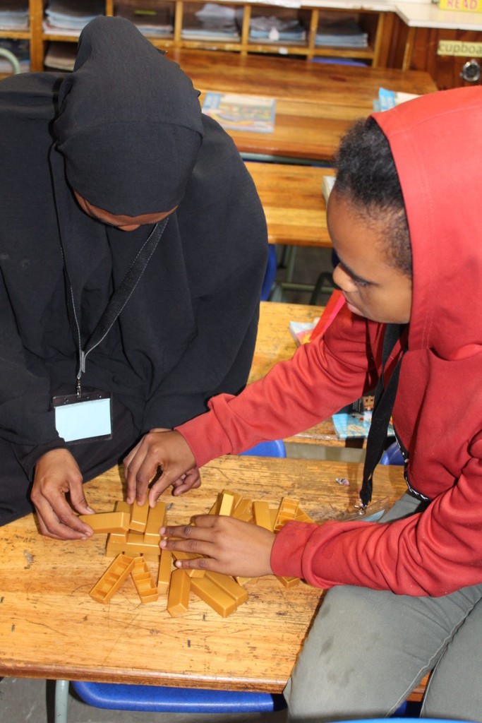 A parent and child play Jenga during the games session of the Family Strengthening Programme at Cascade Primary School.