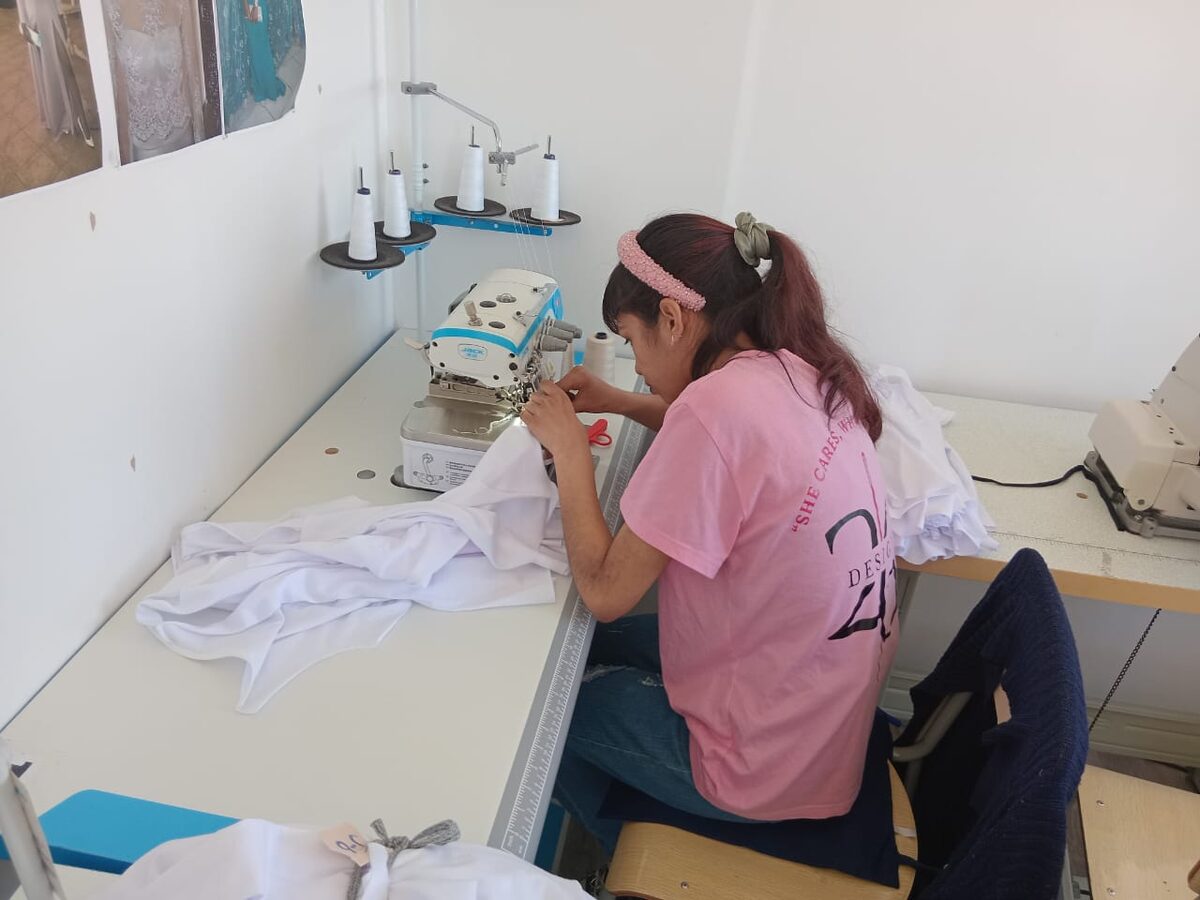 Almaaz Abdullah sews a garment in the Design 26 factory.