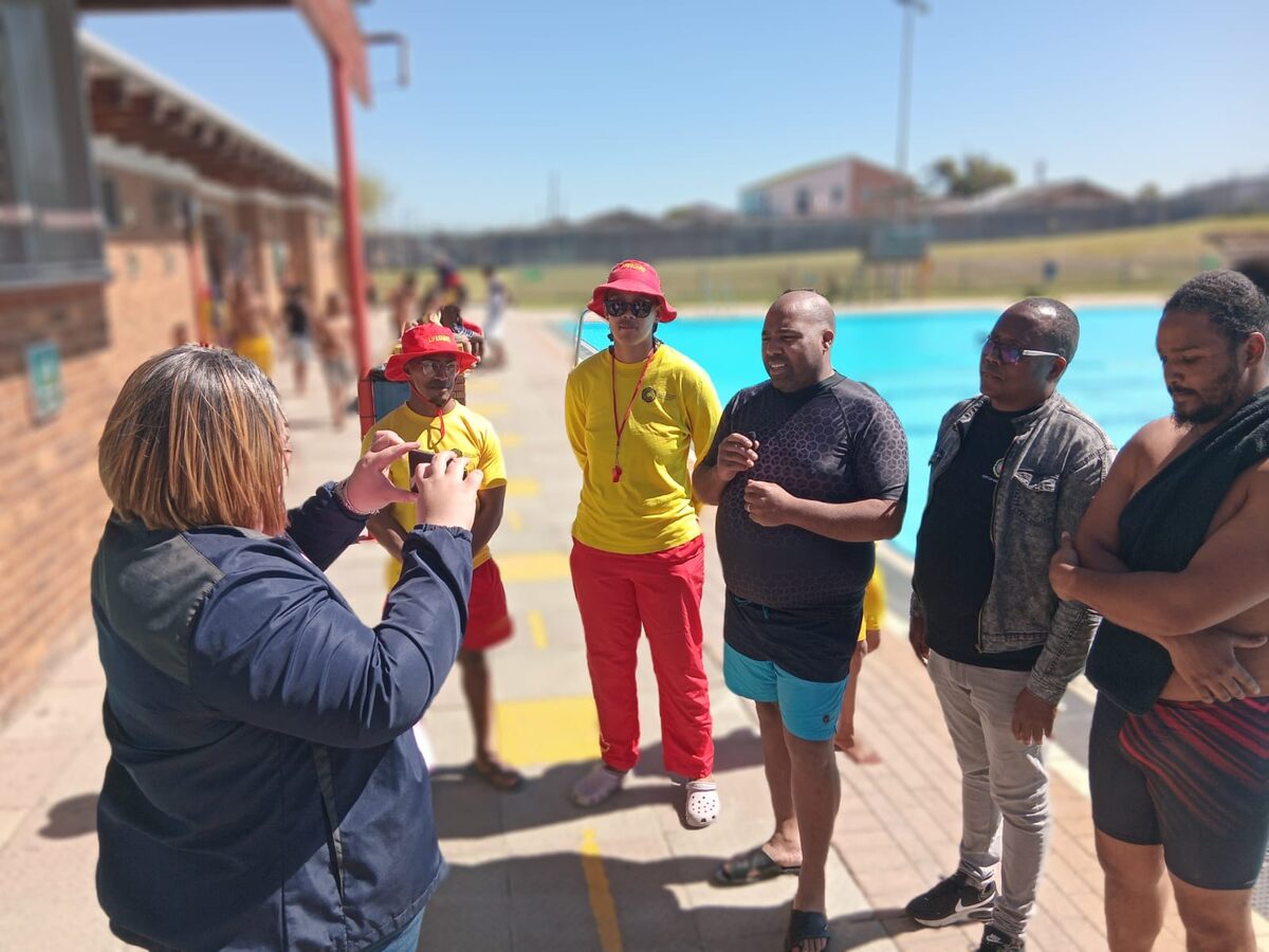 Sub-council 12 staff and lifeguards at Eastridge public swimming pool film a social media video about the opening of the pool on 3 October.
